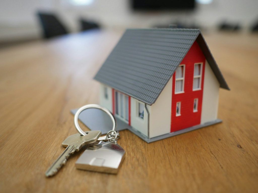 Model house and a set of keys on a desk
